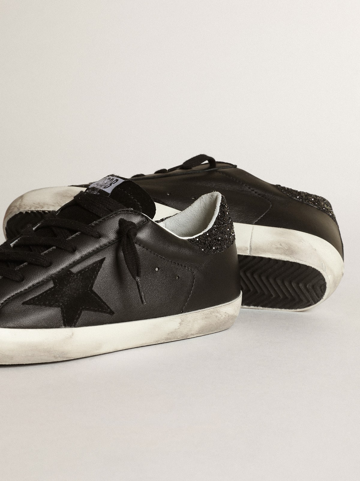 Women's Super-Star in black nappa with black star and glitter heel tab - Golden Goose Women
