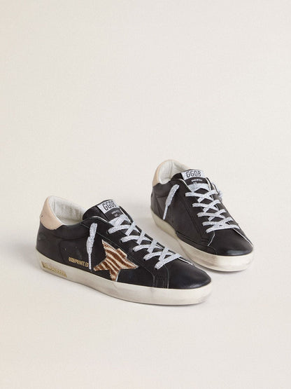 Women’s Super-Star in black nappa leather with zebra-print pony skin star and beige leather heel tab - Golden Goose Women
