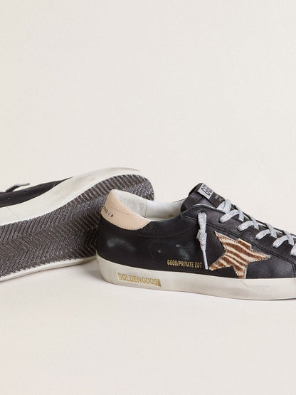 Women’s Super-Star in black nappa leather with zebra-print pony skin star and beige leather heel tab - Golden Goose Women
