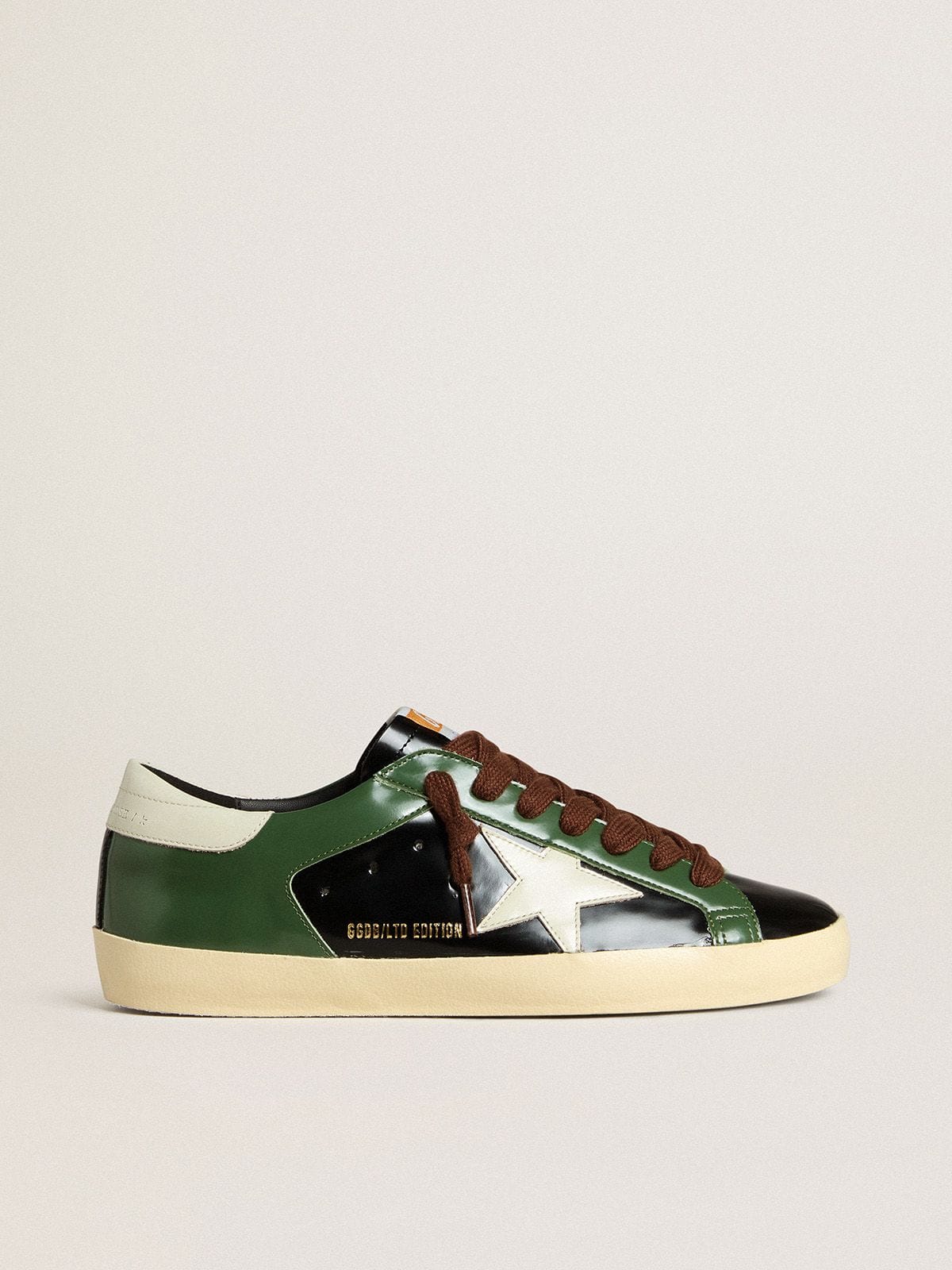 Men’s Super-Star LTD in black laminated leather with white leather star and heel tab - Golden Goose Men