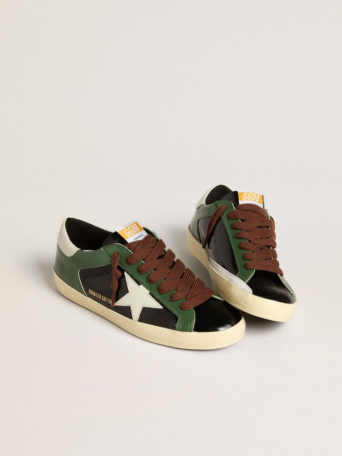 Men’s Super-Star LTD in black laminated leather with white leather star and heel tab - Golden Goose Men