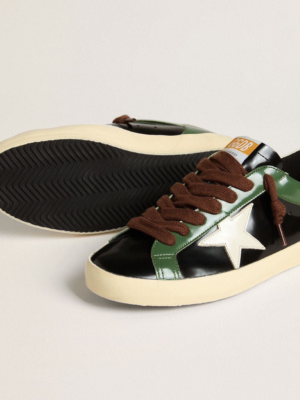 Men’s Super-Star LTD in black laminated leather with white leather star and heel tab - Golden Goose Men